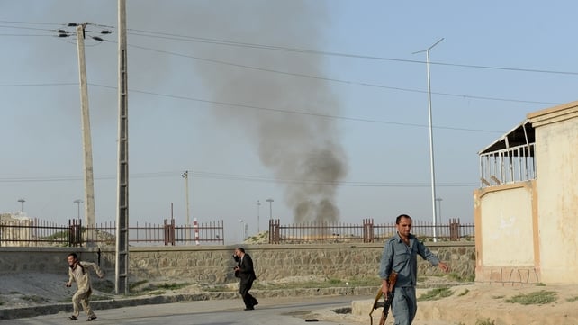 Afghans run for cover at the site of the attack in Kabul Afghans run for cover at the site of the attack in Kabul