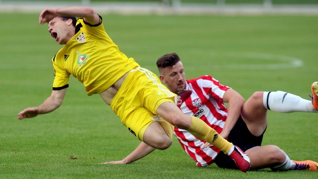 Siarhei Balanovich is tackled by Derry's Shane McEleney