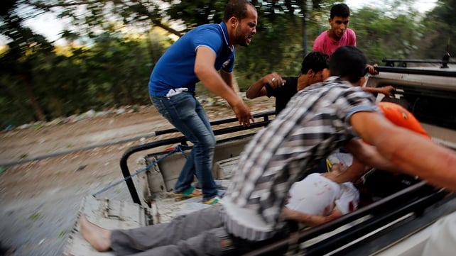Palestinians transport a wounded man after an air strike in Al Tufah neighbourhood in eastern Gaza City Palestinians transport a wounded man after an air strike in Al Tufah neighbourhood in eastern Gaza City