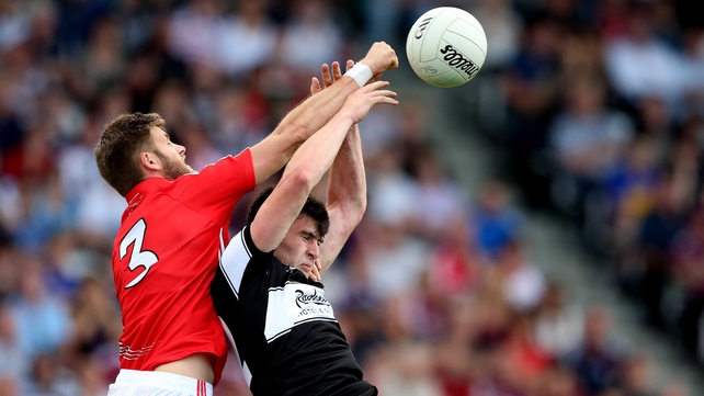 Cork's Eoin Cadogan and Pat Hughes of Sligo battle for the ball