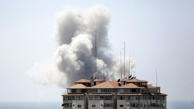 Smoke billows from a building hit by an Israeli air strike in Gaza City Smoke billows from a building hit by an Israeli air strike in Gaza City