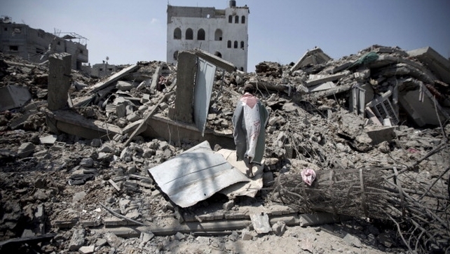 A Palestinian man inspects the rubble of destroyed buildings and houses in Gaza City A Palestinian man inspects the rubble of destroyed buildings and houses in Gaza City