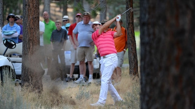 Padraig Harrington plays a shot out of the woods on the fifth hole
