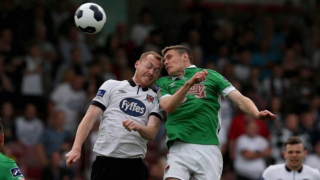Chris Shileds of Dundalk and Cork's Garry Buckley challenge in the air