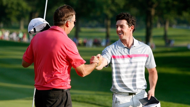 Rory McIlroy celebrates with caddie JP Fitzgerald after his winning putt in the final round of the World Golf Championships