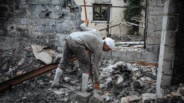 A man tidies up a destroyed cafe after fighting between militants and Ukrainian forces near Slaviansk A man tidies up a destroyed cafe after fighting between militants and Ukrainian forces near Slaviansk