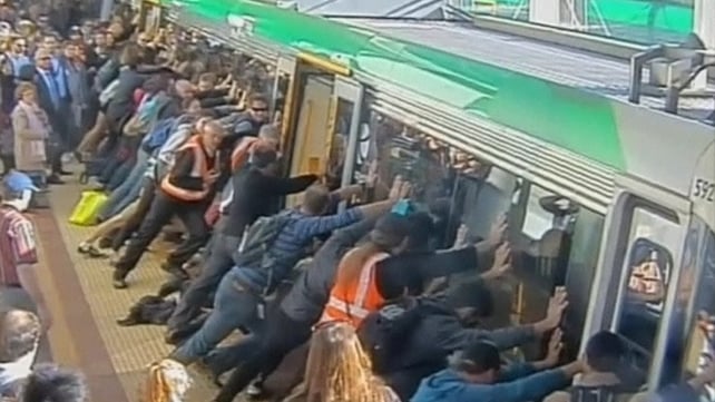 Commuters in Perth tilted the train so the man could be freed Commuters in Perth tilted the train so the man could be freed