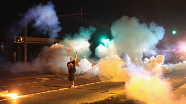 A demonstrator stands his ground as police fire tear gas A demonstrator stands his ground as police fire tear gas