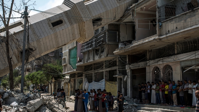 Palestinians attend Friday noon prayers in the shadow of a toppled minaret at Al-Susi Mosque in Gaza City Palestinians attend Friday noon prayers in the shadow of a toppled minaret at Al-Susi Mosque in Gaza City