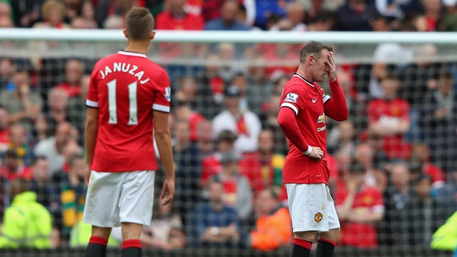 Wayne Rooney holds his head in despair during United's defeat to Swansea