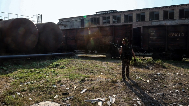 A militia member checks damage after an apparent shelling by the Ukrainian army near Donetsk A militia member checks damage after an apparent shelling by the Ukrainian army near Donetsk
