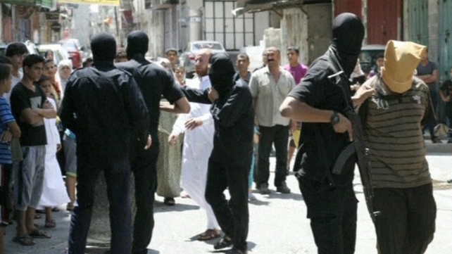 The victims, their heads covered and hands tied, were shot dead by masked gunmen The victims, their heads covered and hands tied, were shot dead by masked gunmen