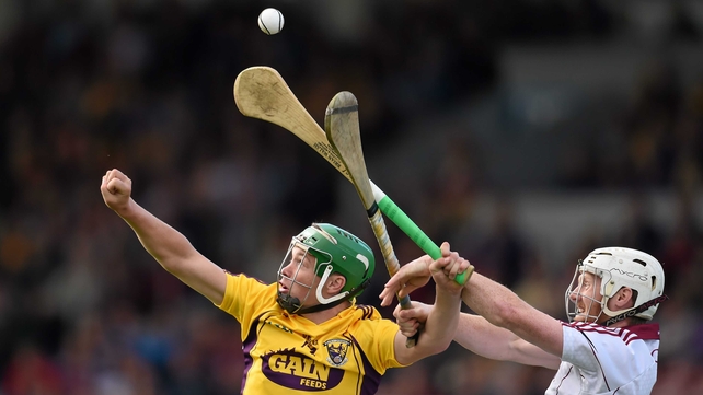 Galway's John Hanbury (R) contests a ball with Wexford's Conor McDonald