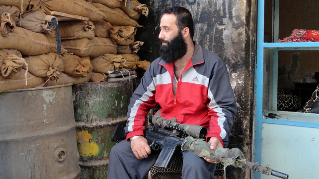 An rebel fighter defends a position in a rebel-held suburb of Damascus in Syria An rebel fighter defends a position in a rebel-held suburb of Damascus in Syria