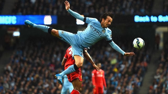 Raheem Sterling of Liverpool tangles with David Silva of Manchester City