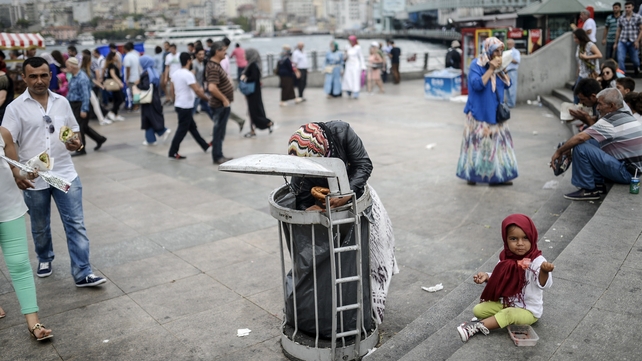 A Syrian child eats food which her mother collects from rubbish in Italy - one of the country's refugees are fleeing to A Syrian child eats food which her mother collects from rubbish in Italy - one of the country's refugees are fleeing to