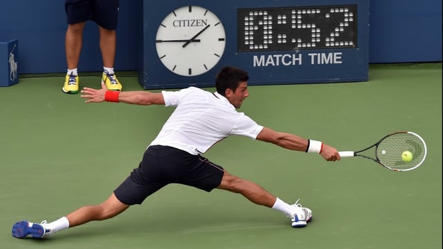 Novak Djokovic shows off his legendary defensive qualities with a lunging return at Flushing Meadows