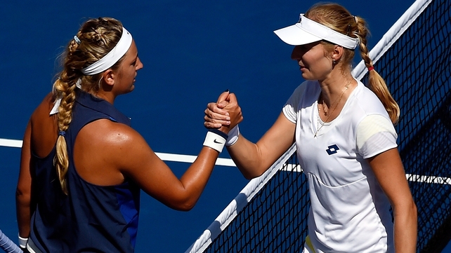 Ekaterina Makarova (r) of Russia shakes hands Victoria Azarenka