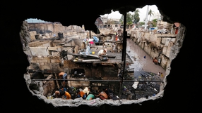 Residents salvage materials among debris following a fire that razed a slum area in Quezon city, east of Manila