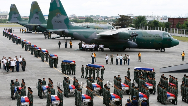 Members of elite Police Special Action Force carry the remains of colleagues who were killed in fighting with Muslim rebels in the southern Philippines Members of elite Police Special Action Force carry the remains of colleagues who were killed in fighting with Muslim rebels in the southern Philippines