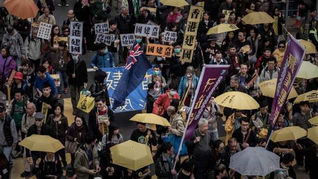 Around 12,000 people marched through Hong Kong's shopping and financial districts Around 12,000 people marched through Hong Kong's shopping and financial districts