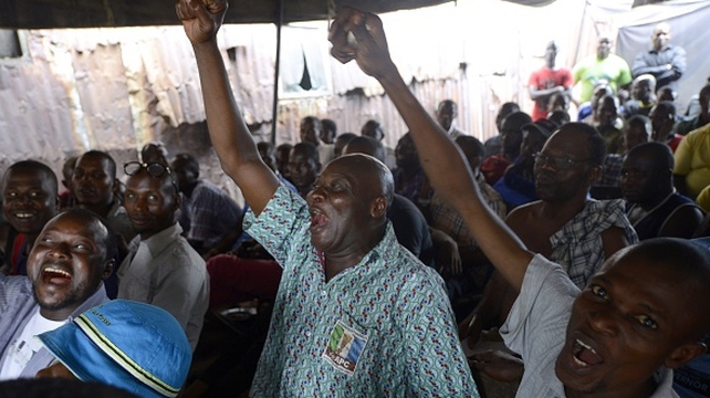 People react as results of the election show opposition challenger Muhammadu Buhari ahead