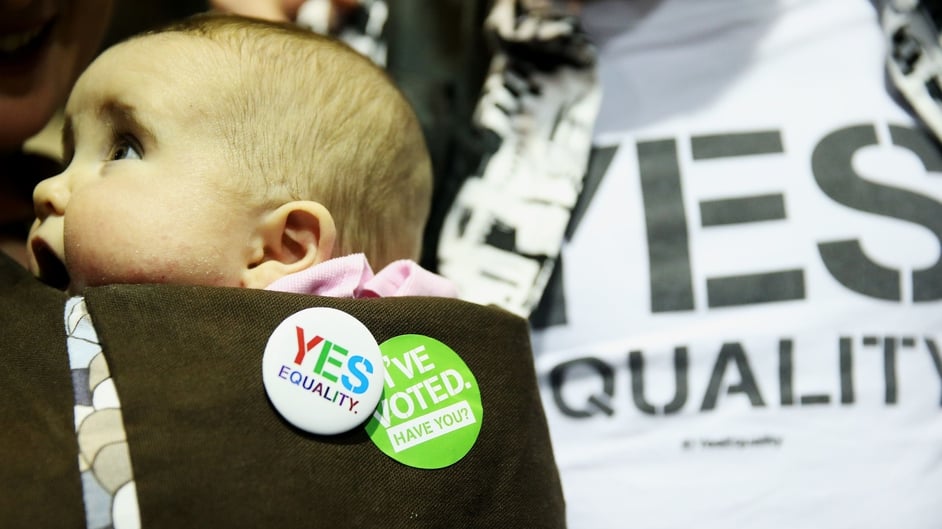 Seven month old Belle Duffy, held by her mother Deirdre Duffy, as counting of votes continues in the referendums on same-sex marriage and presidential-age