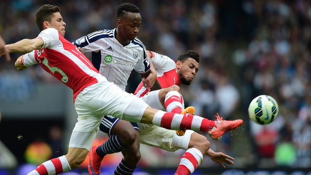 Gabriel tackles Saido Berahino of West Brom in the Premier League