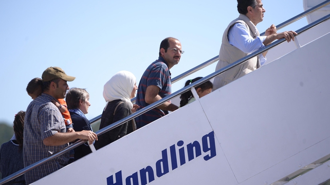 A group of Syrian refugees boards a plane with Pope Francis at the airport of Mytilene, on the island of Lesbos