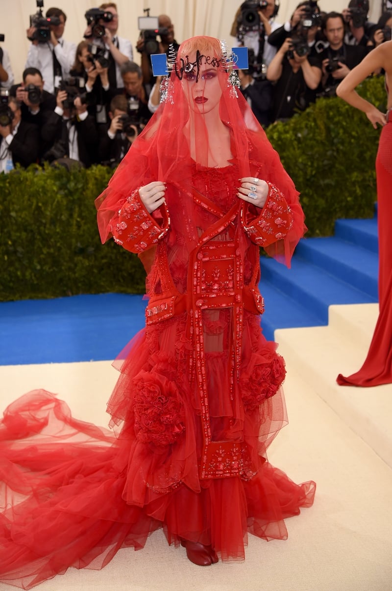 Would you recognise the famous pop singer under this red veil? Katy Perry is an unusual Madonna in this Maison Margiela number.