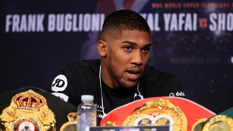 Anthony Joshua speaking at a press conference ahead of his fight with Carlos Takam