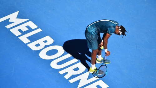 Gael Monfils doubled over and struggling during his second round loss to Novak Djokovic