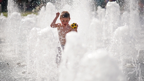 A young boy cools off in the fountains in Piccadilly Gardens in Manchester A young boy cools off in the fountains in Piccadilly Gardens in Manchester