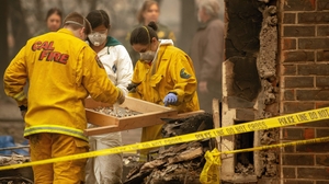 Rescue workers sift debris for human remains at a burned residence in Paradise Rescue workers sift debris for human remains at a burned residence in Paradise