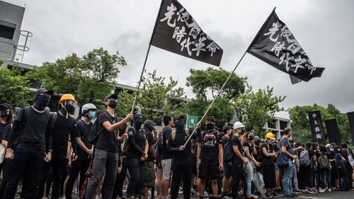 Hong Kong protesters target airport but planes are running