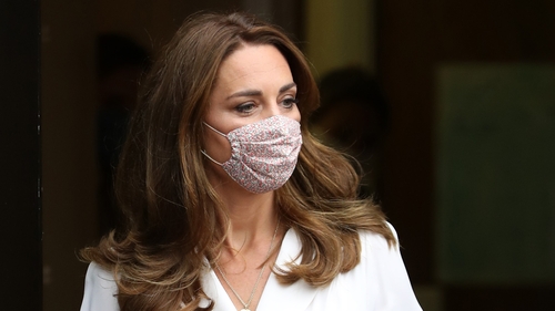 Kate accessorises sleek white dress with floral face mask Kate accessorises sleek white dress with floral face mask