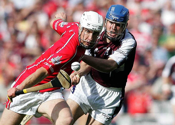 Cork's Timmy McCarthy and Galway's David Collins battle for posession