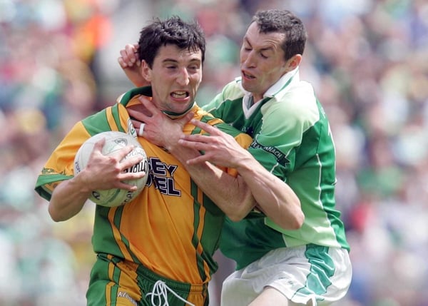 Michael Hegarty is accosted by Fermanagh's Raymond Johnston