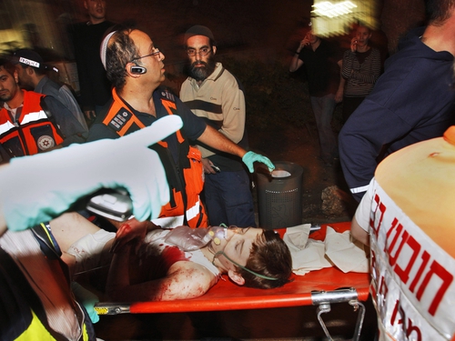 Jerusalem - Paramedics attend to a boy injured in the attack