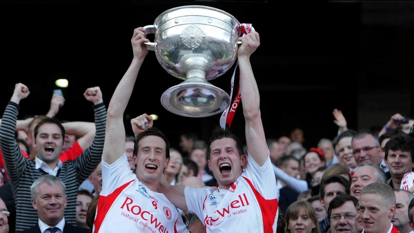 Sean Cavanagh (r) lifts Sam Maguire with his brother Colm