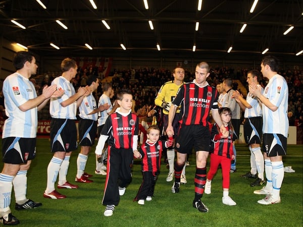 Bohemians' captain Owen Heary leads out his team as the Derry City players form a guard of honor