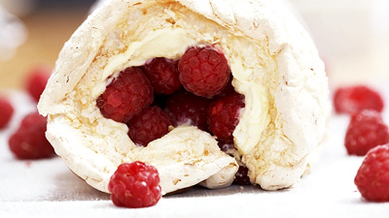 Coconut meringue roulade with lemon curd cream and raspberries