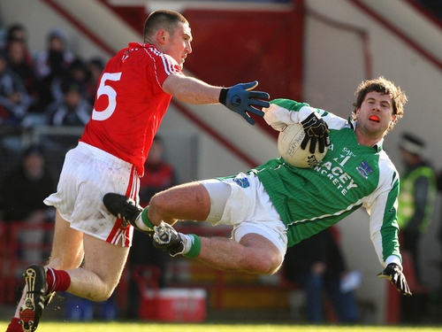 Fermanagh's Ryan Keenan feels the fill force of a Noel O'Leary tackle