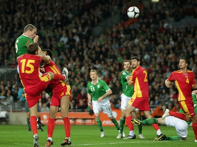 Richard Dunne smacks a header off the crossbar against Montenegro at Croke Park