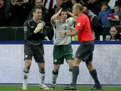 Shea Given and Sean St Ledger protest to the referee after Thierry Henry handled the ball in the run up to France's goal.