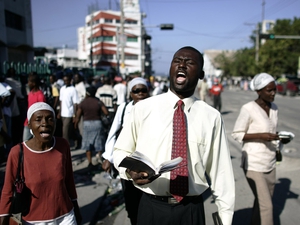 After a mass in Port Au Prince, residents walk the streets singing hymns