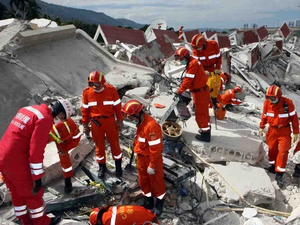 A Chinese emergency rescue team searches a collapsed building