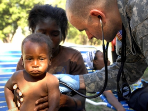 A US Army medic treats a child