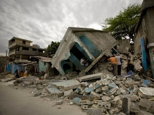 Haitians look for survivors under the rubble in the Belair neighborhood