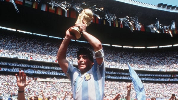 Diego Maradona holds the famous trophy aloft